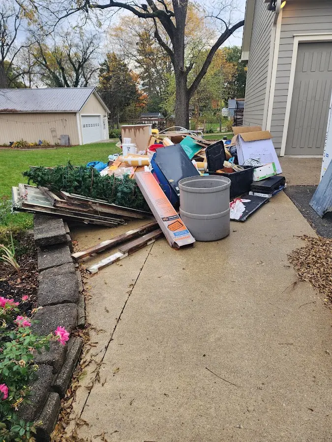 Dumpster being loaded with debris for Residential Dumpster Rental in Fitchburg